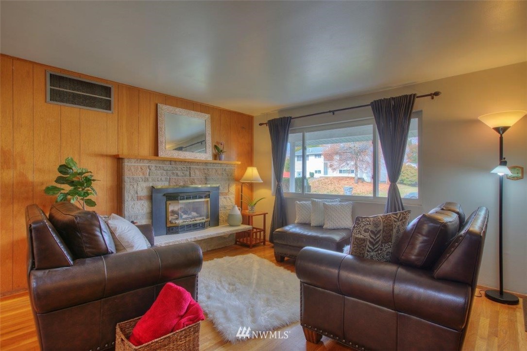 4209 Northeast 11th Street Renton, WA 98059 - Photo 8 of 17 a living room with furniture and a fireplace