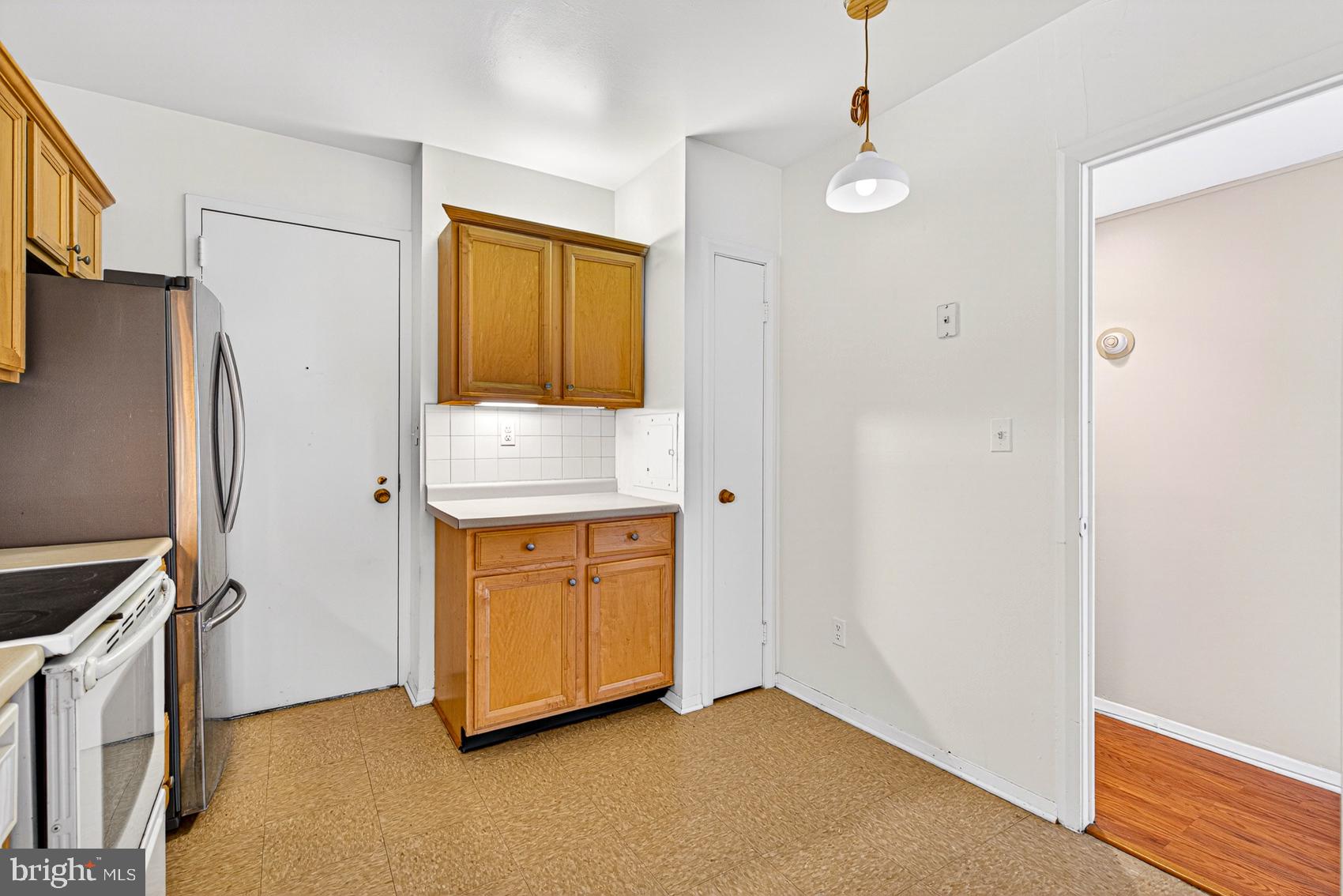 3601 Clarks Lane, Unit 418 Baltimore, MD 21215 - Photo 11 of 28 a bathroom with a granite countertop sink a mirror and a shower