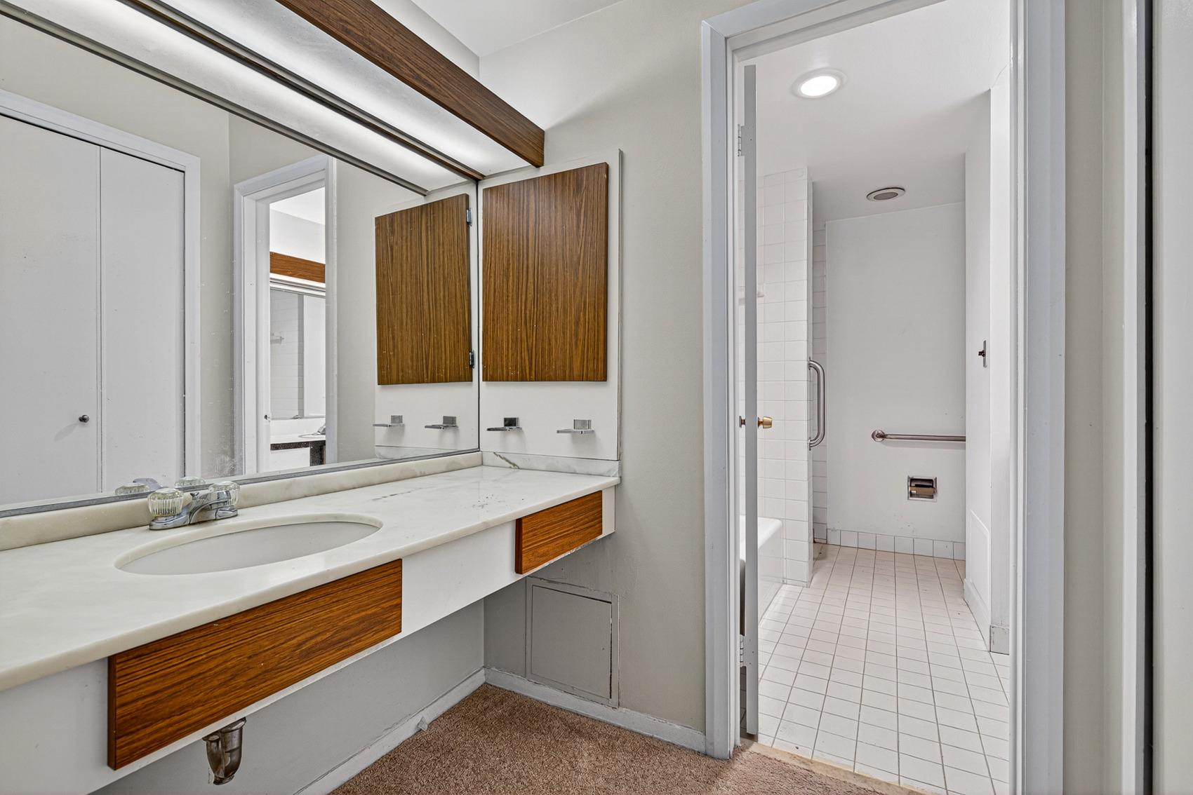 3601 Clarks Lane, Unit 418 Baltimore, MD 21215 - Photo 19 of 28 a bathroom with a sink double vanity and a mirror