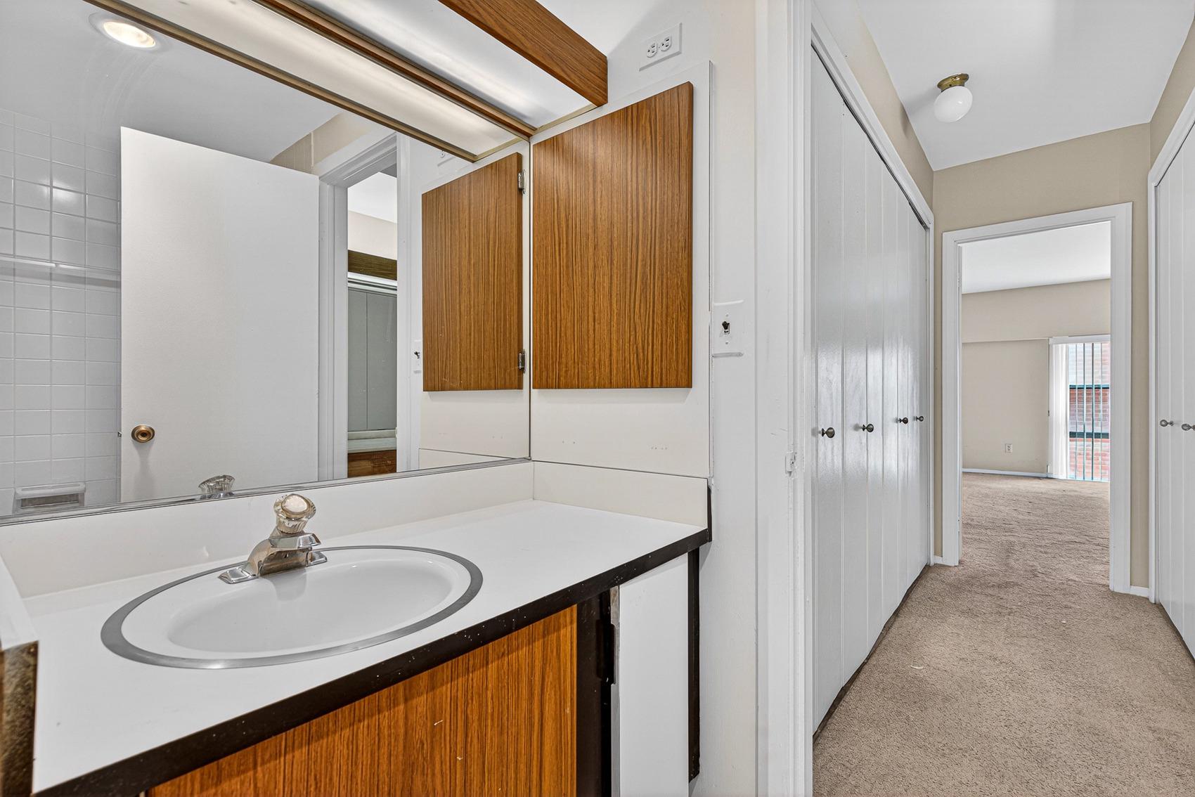 3601 Clarks Lane, Unit 418 Baltimore, MD 21215 - Photo 20 of 28 a bathroom with a sink and a mirror