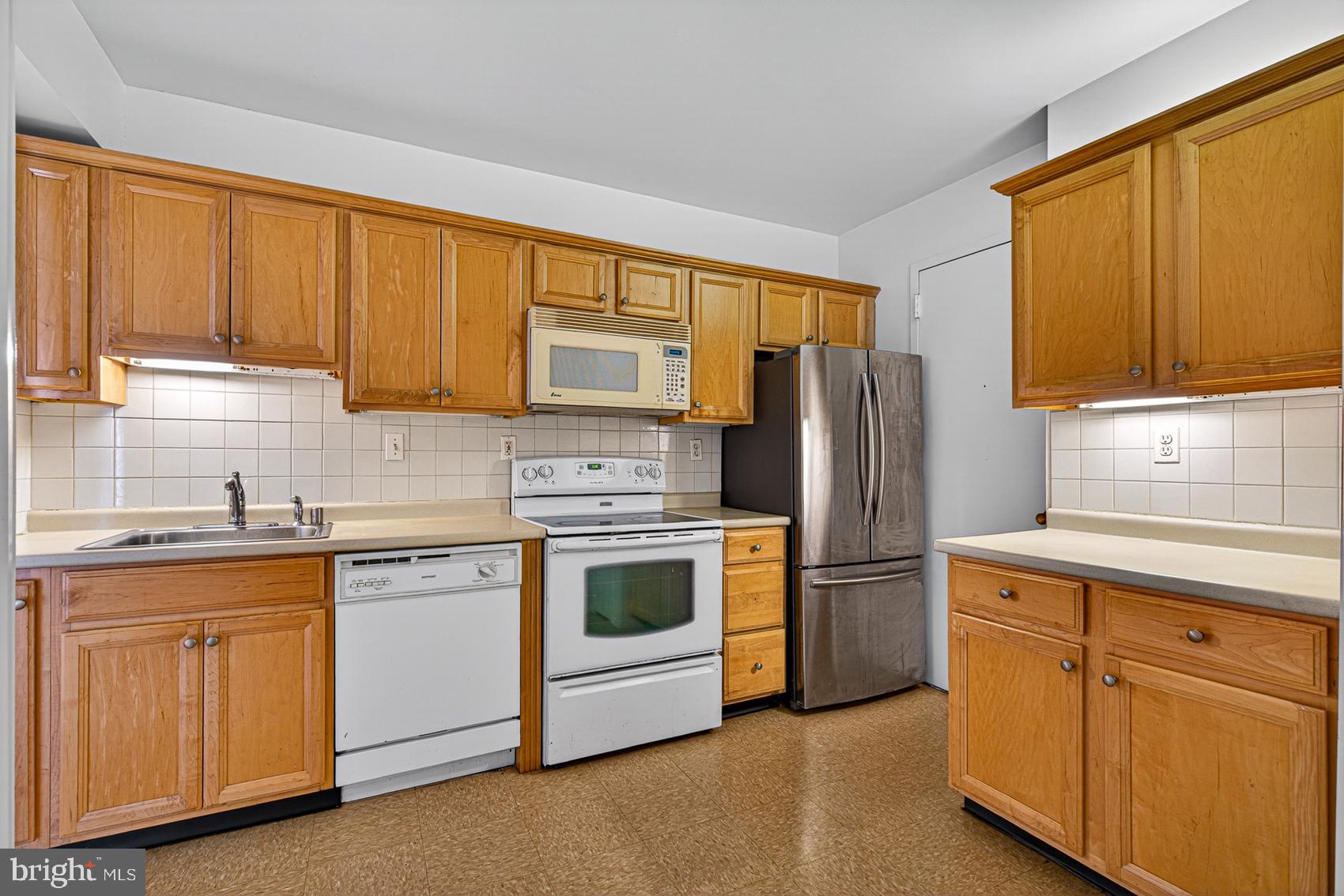 3601 Clarks Lane, Unit 418 Baltimore, MD 21215 - Photo 10 of 28 a kitchen with cabinets stainless steel appliances and a window