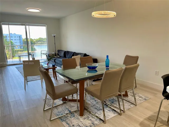 a dining room with furniture and a window