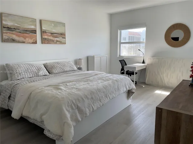 a spacious bedroom with a bed and window