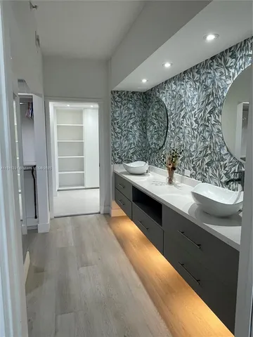 a bathroom with a double vanity sink a and a mirror