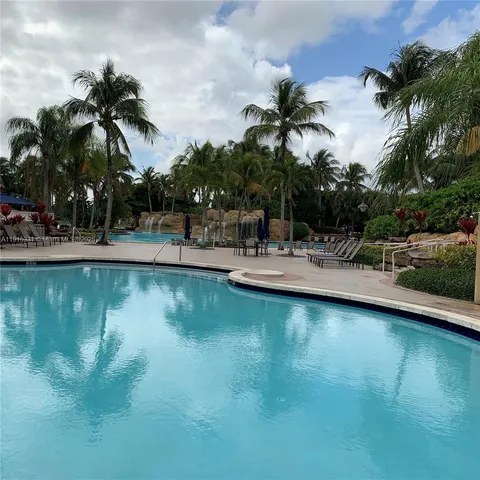 a view of a swimming pool with a table and chairs