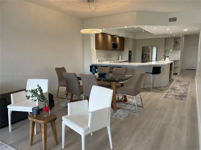 a living room with furniture and kitchen view