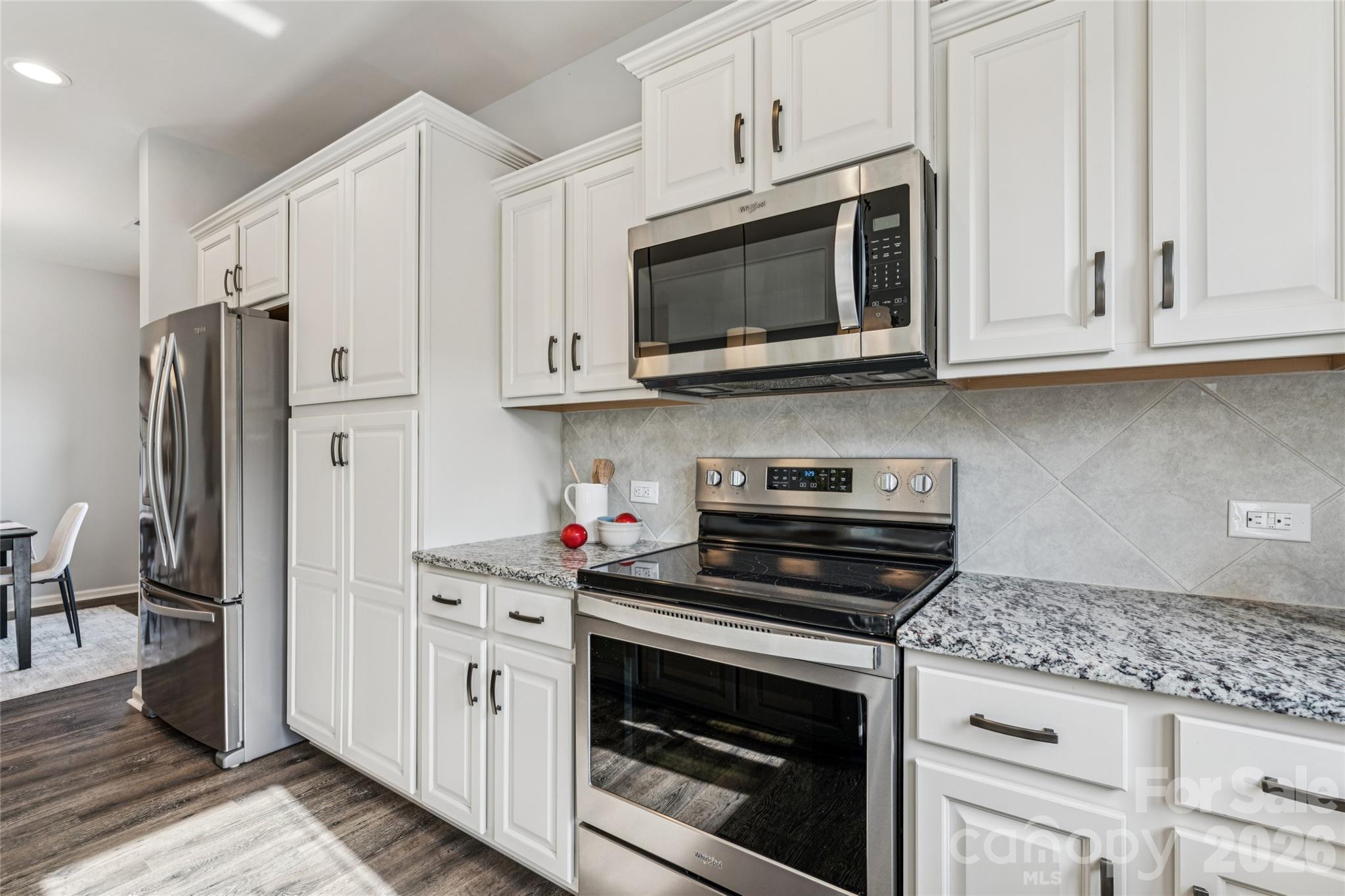 50139 Robins Nest Lane Lancaster, SC 29720 - Photo 4 of 30 a kitchen with stainless steel appliances granite countertop grey cabinets a stove a microwave and a refrigerator