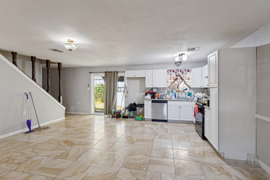 4709 Baton Rouge Street Houston, TX 77028 - Photo 10 of 16 Polished tile flooring sweeps across this open kitchen and dining area.