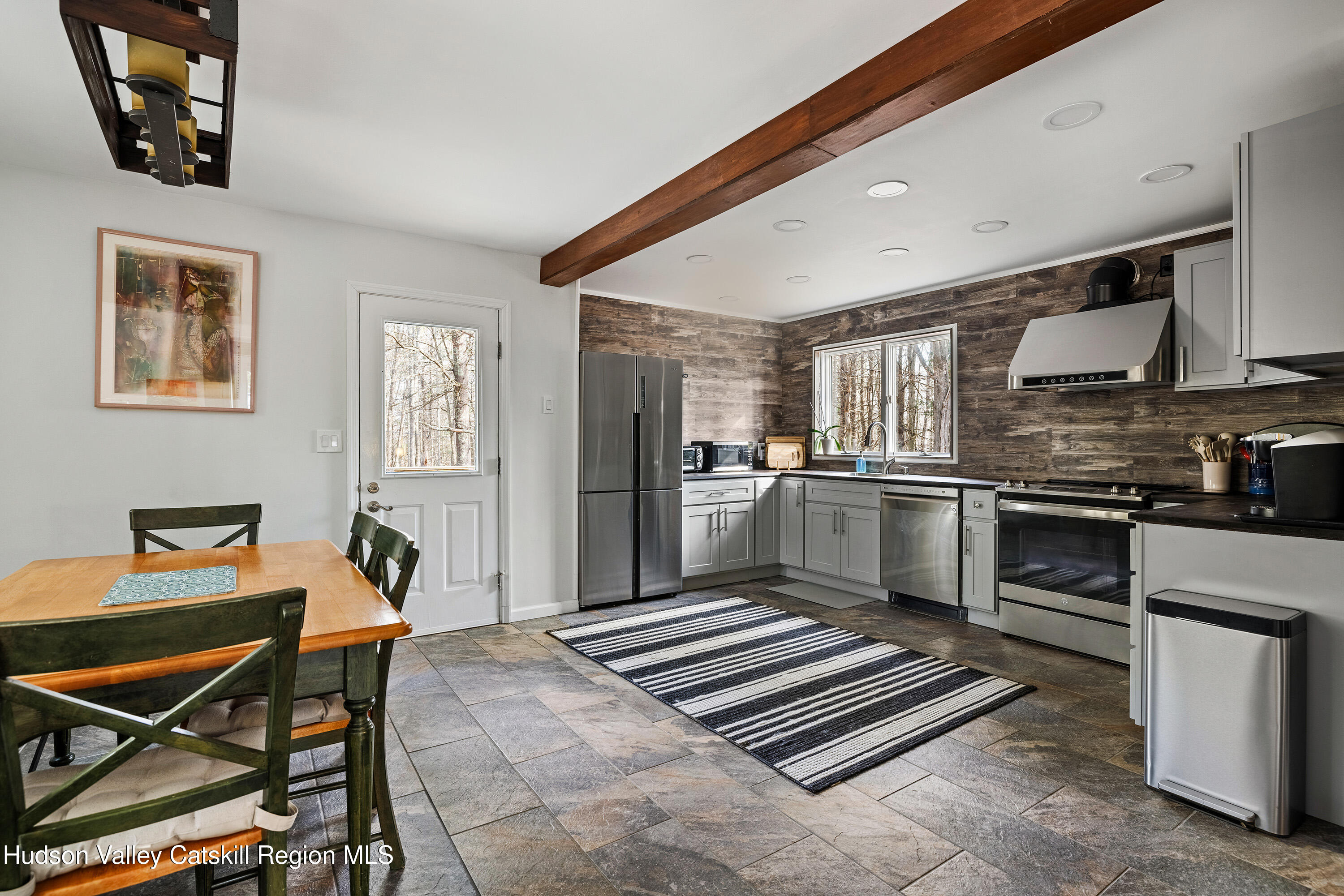150 Vining Road Windham, NY 12496 - Photo 17 of 49 a kitchen with stainless steel appliances kitchen island granite countertop a refrigerator and microwave