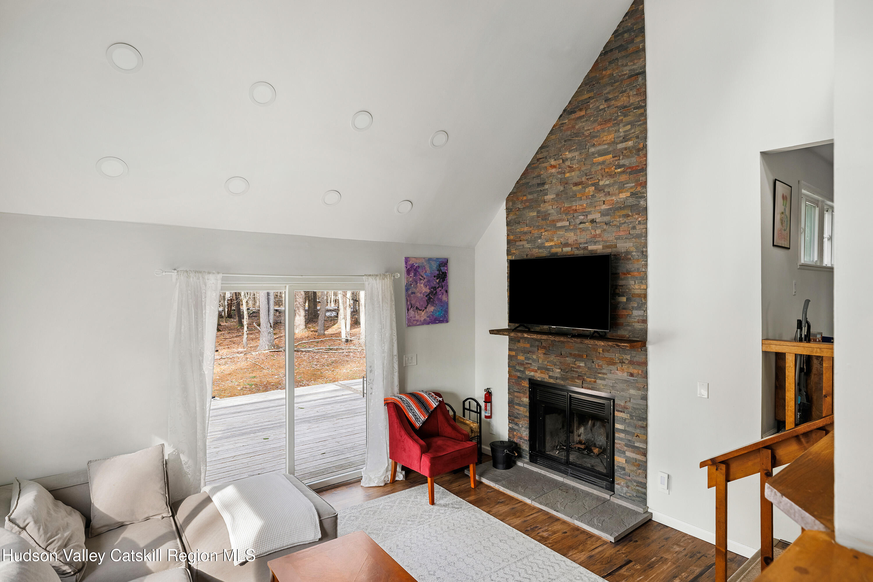 150 Vining Road Windham, NY 12496 - Photo 23 of 49 a living room with furniture a flat screen tv and a fireplace