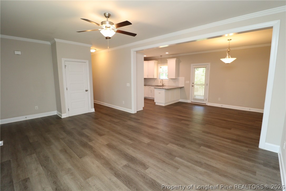 8424 Rhodes Road Apex, NC 27539 - Photo 4 of 31 a view of an empty room with window and wooden floor