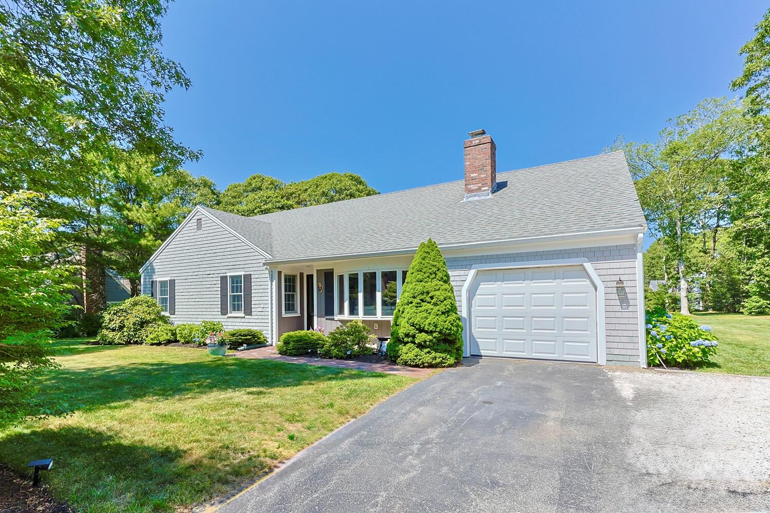 a front view of house with yard and green space