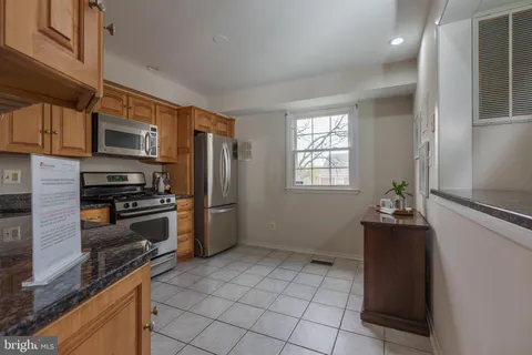 a kitchen with a refrigerator and a stove