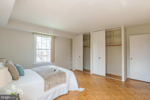 a spacious bedroom with a bed and a window