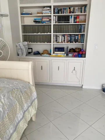 a living room with furniture and large windows