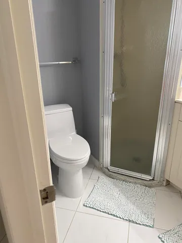 a bedroom with a bed and a lamp