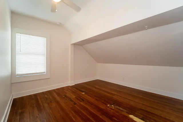 a bathroom with a granite countertop sink a toilet and shower