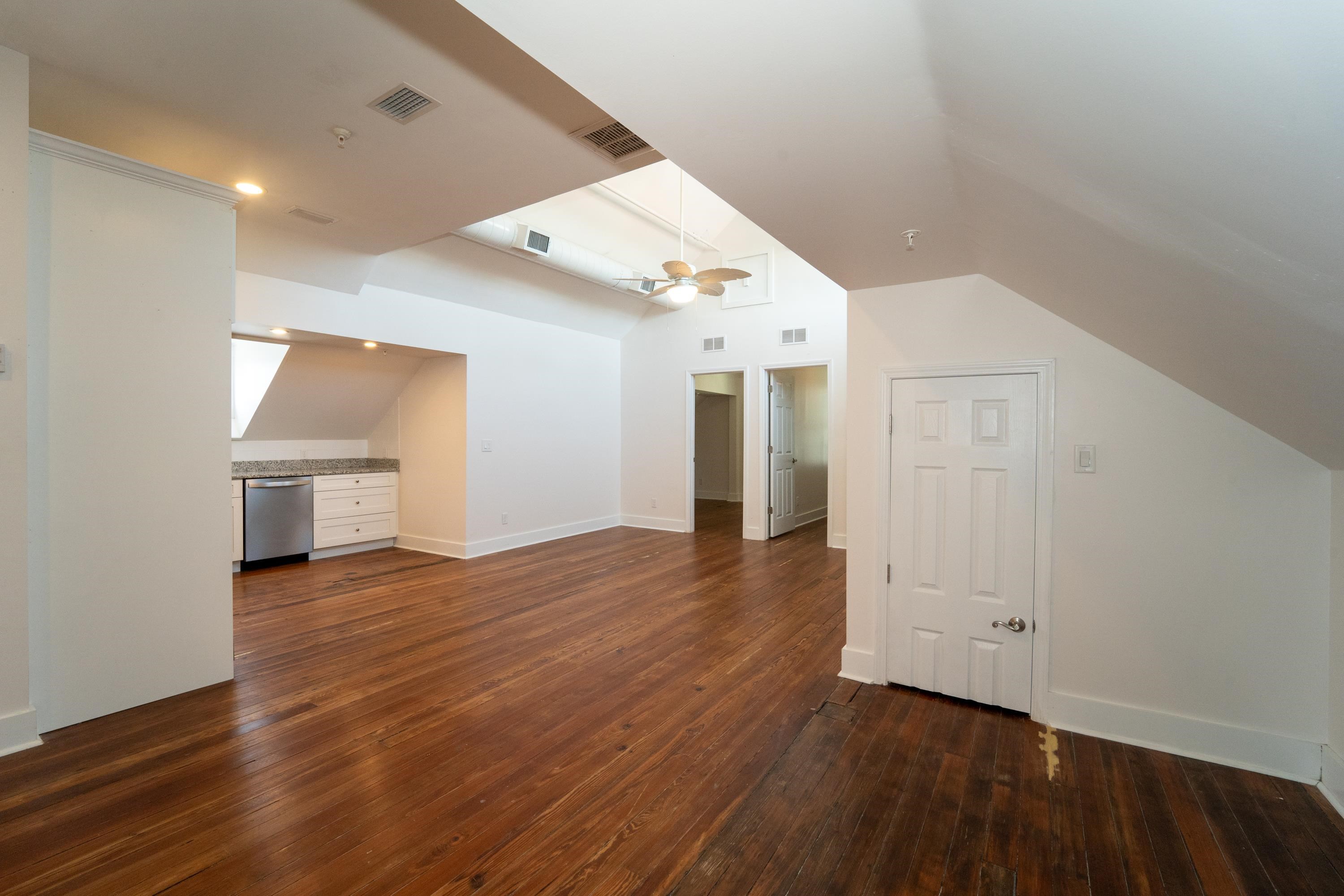 11 Aviles Street, Unit 3B St. Augustine, FL 32084 - Photo 5 of 17 an empty room with wooden floor and windows