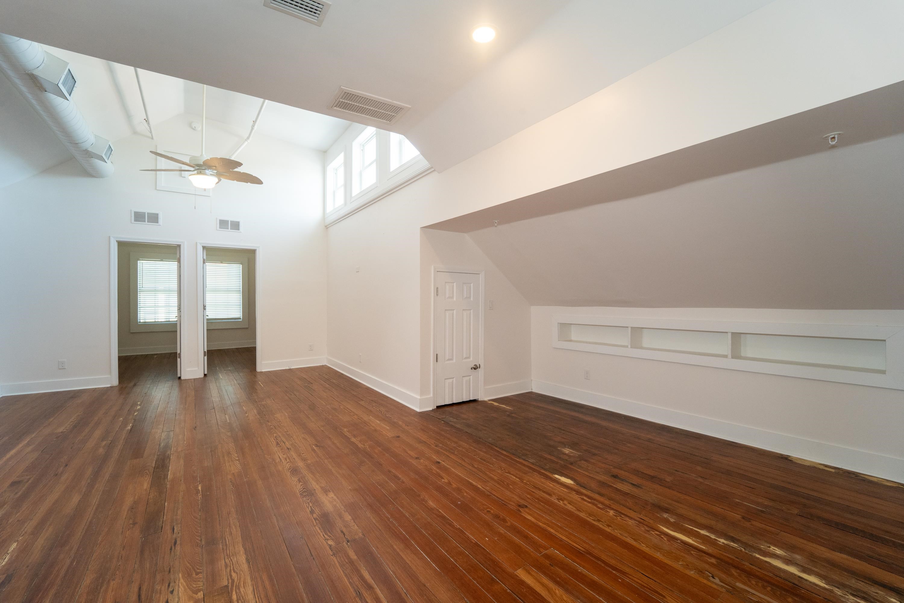 11 Aviles Street, Unit 3B St. Augustine, FL 32084 - Photo 6 of 17 a view of an empty room with wooden floor and a window