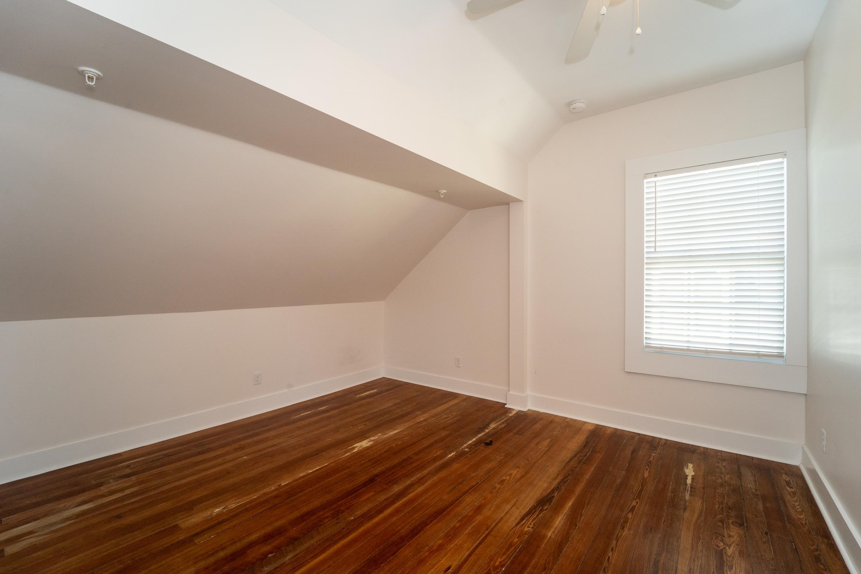 11 Aviles Street, Unit 3B St. Augustine, FL 32084 - Photo 10 of 17 a view of an empty room with wooden floor and a window
