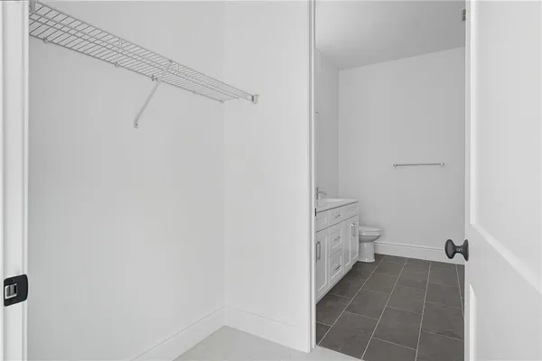 a bathroom with a granite countertop shower and a sink