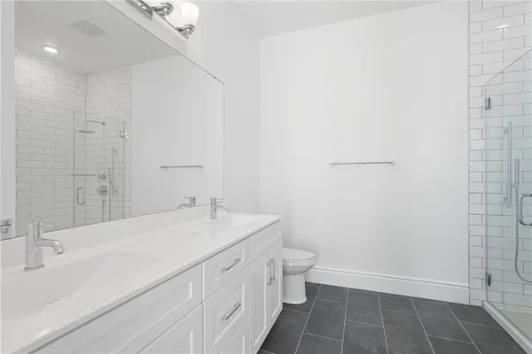 a bathroom with a sink a toilet and a shower