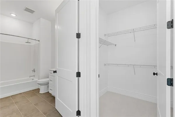 a bathroom with a shower a toilet and a shower