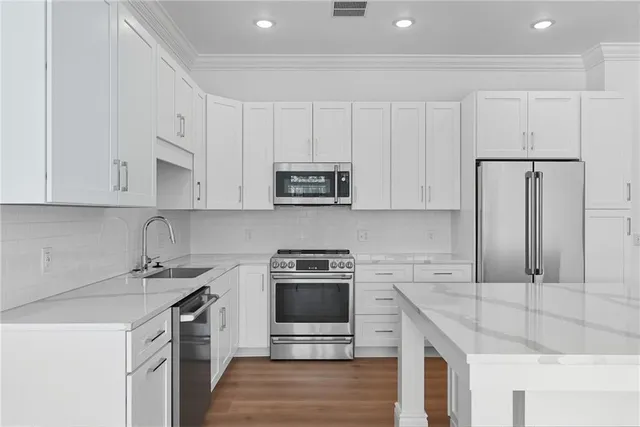a kitchen with granite countertop a sink stove and cabinets