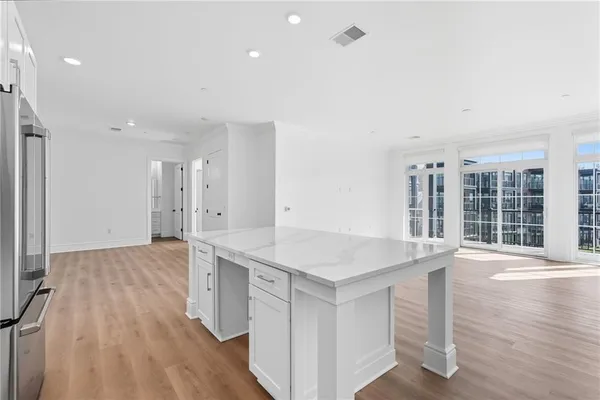 a view of a kitchen with wooden floor and windows