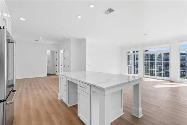 a view of a kitchen with wooden floor and windows