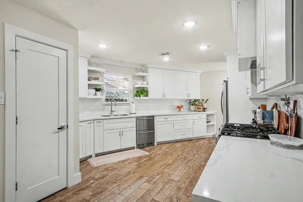 a kitchen with refrigerator and cabinets