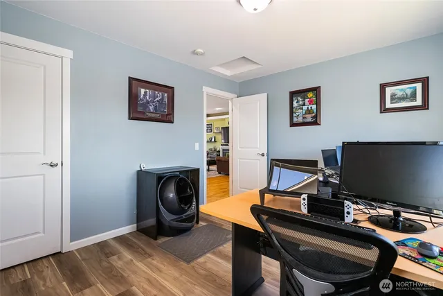 a view of a workspace with furniture and a window