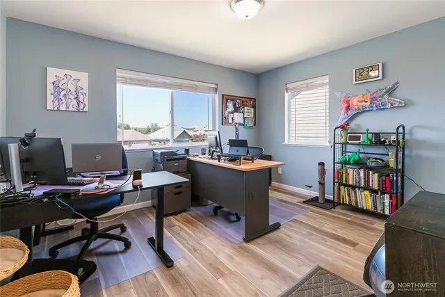 a dining room with a wooden table and chairs