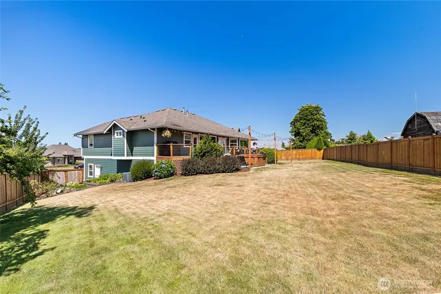 a view of a house with backyard porch and sitting area