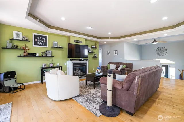 a living room with fireplace furniture and a flat screen tv