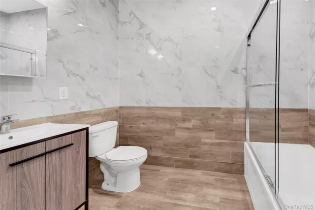 a bathroom with a toilet a sink and a shower