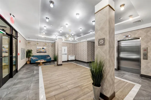 a view of a room with kitchen and windows