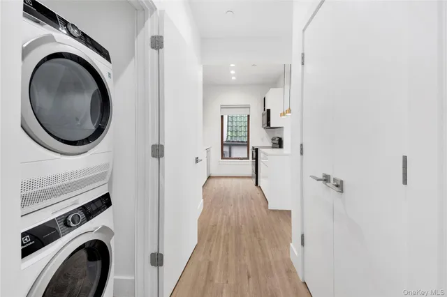 a view of a hallway with washer and dryer