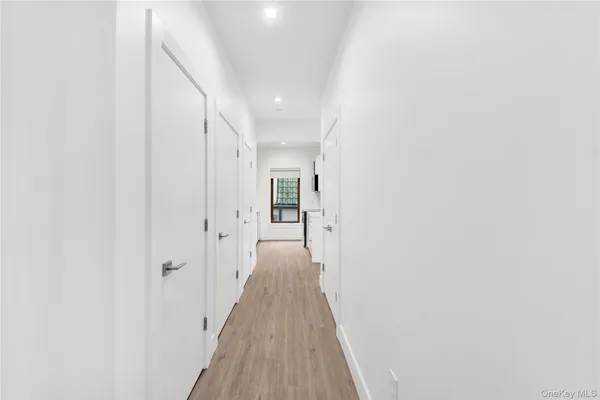 a view of a hallway with wooden floor