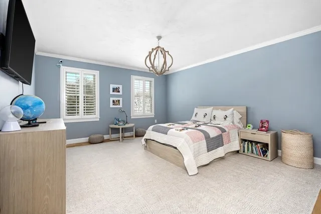 a spacious bedroom with a bed and a window