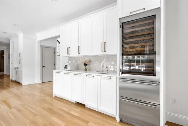 a kitchen with granite countertop white cabinets and white appliances
