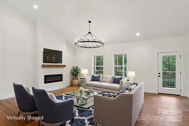 a living room with furniture a fireplace and a flat screen tv