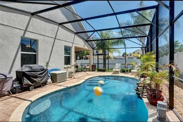 a view of a swimming pool with a patio