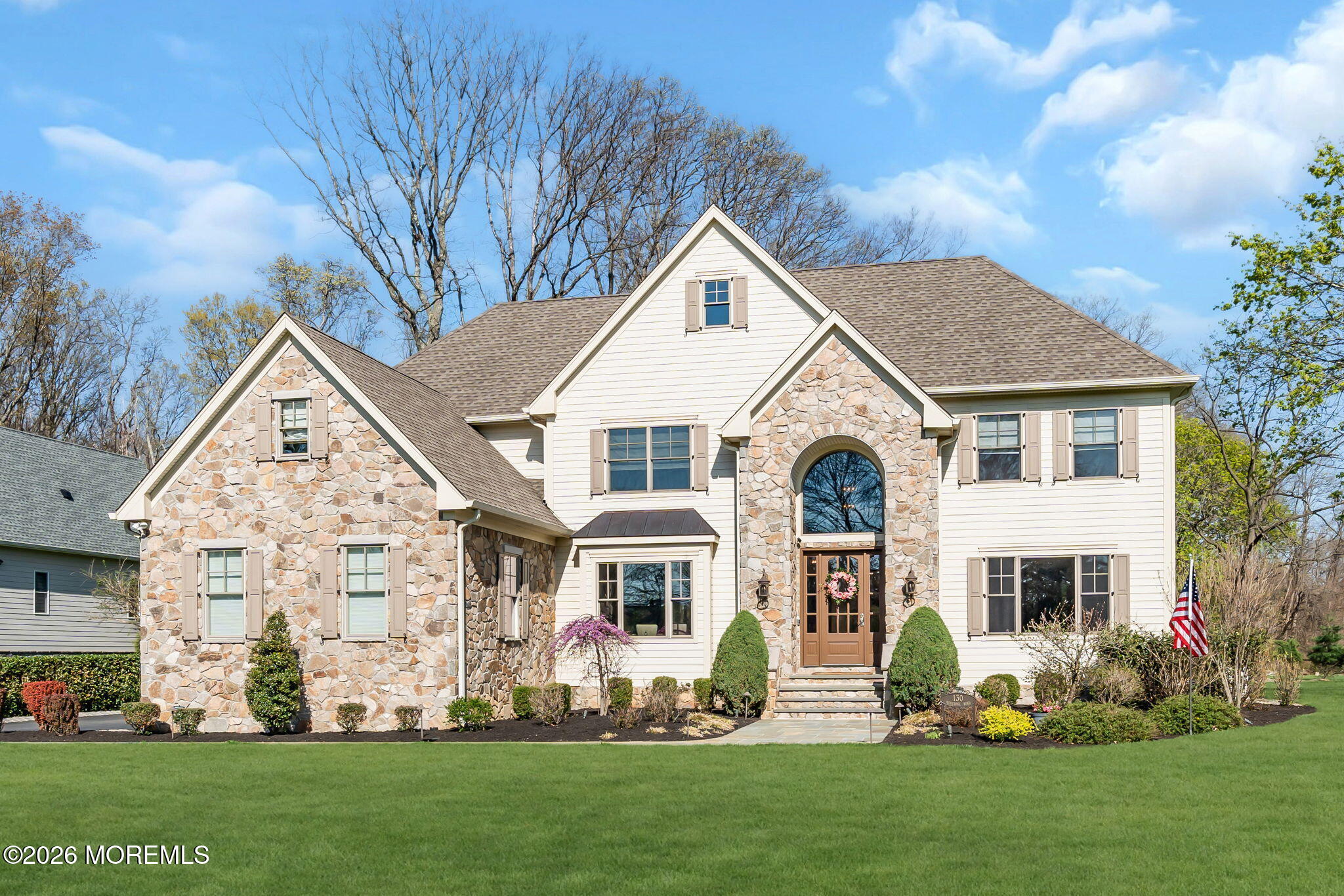 a front view of a house with a garden and plants