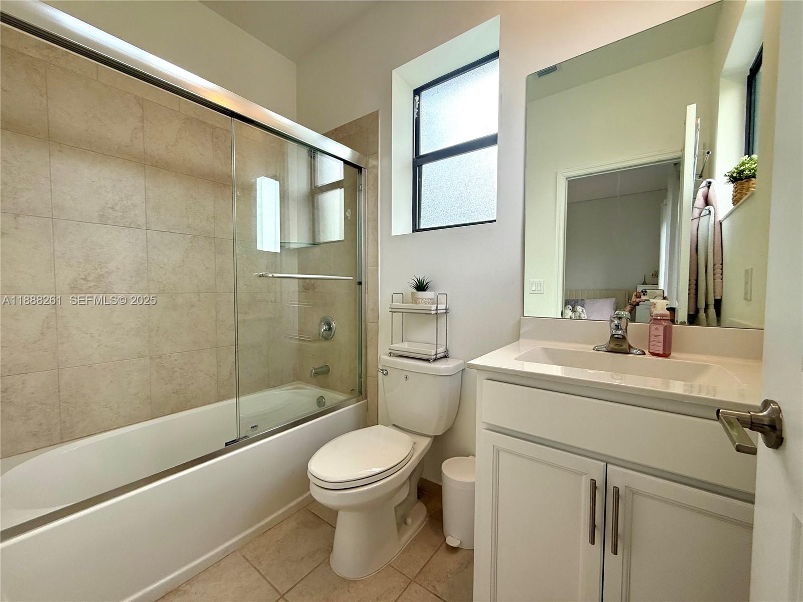 400 Northeast 208th Terrace, Unit 400 Miami, FL 33179 - Photo 12 of 53 a bathroom with a sink a toilet and shower