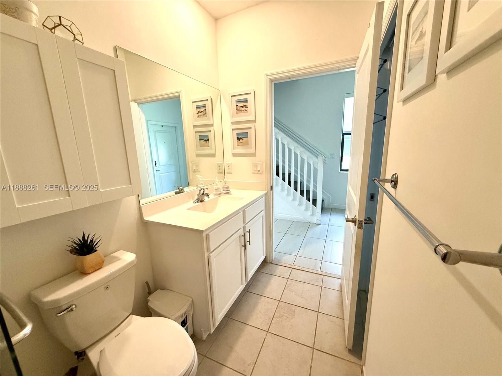 400 Northeast 208th Terrace, Unit 400 Miami, FL 33179 - Photo 15 of 53 a bathroom with a sink a toilet and a mirror