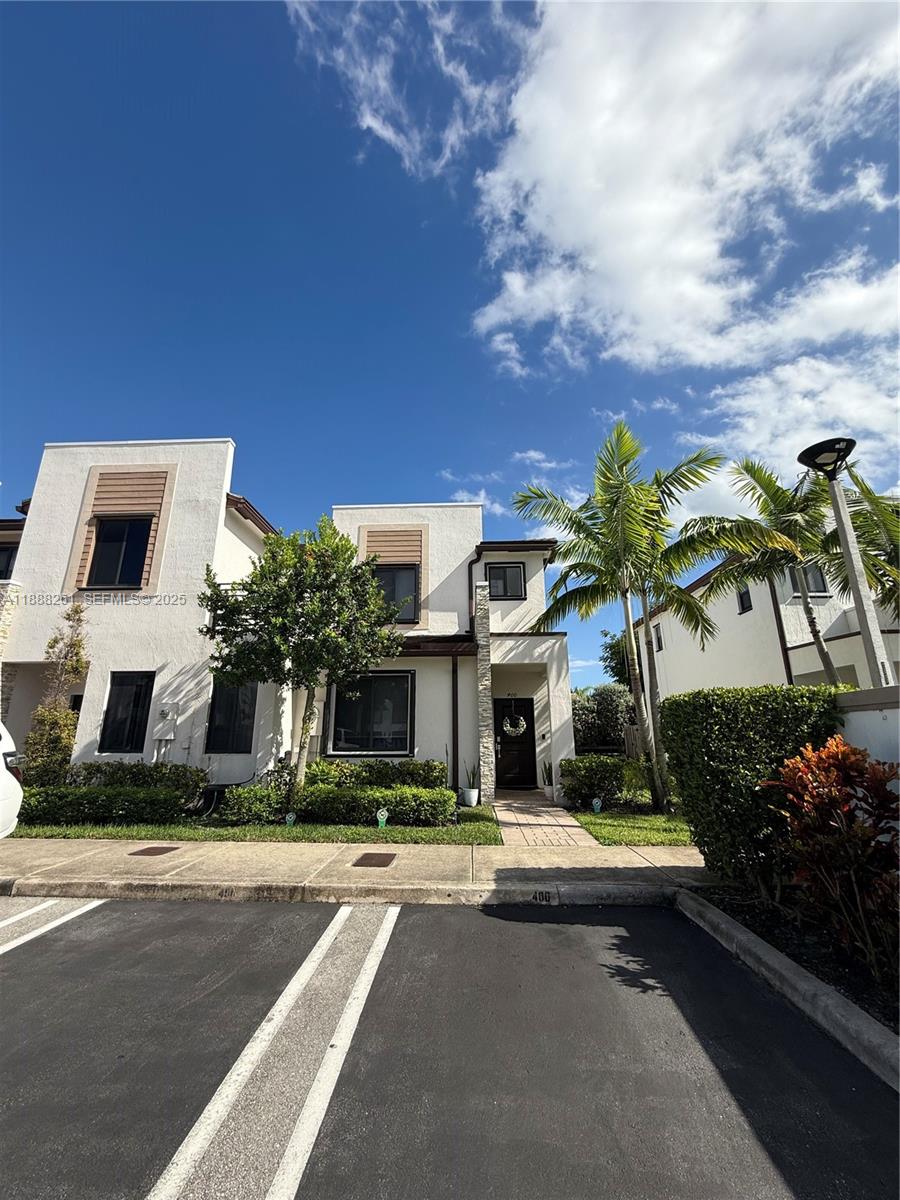 400 Northeast 208th Terrace, Unit 400 Miami, FL 33179 - Photo 24 of 53 a front view of multiple houses with yard