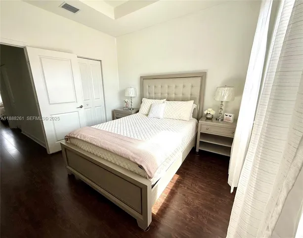 a bedroom with a bed and a dresser