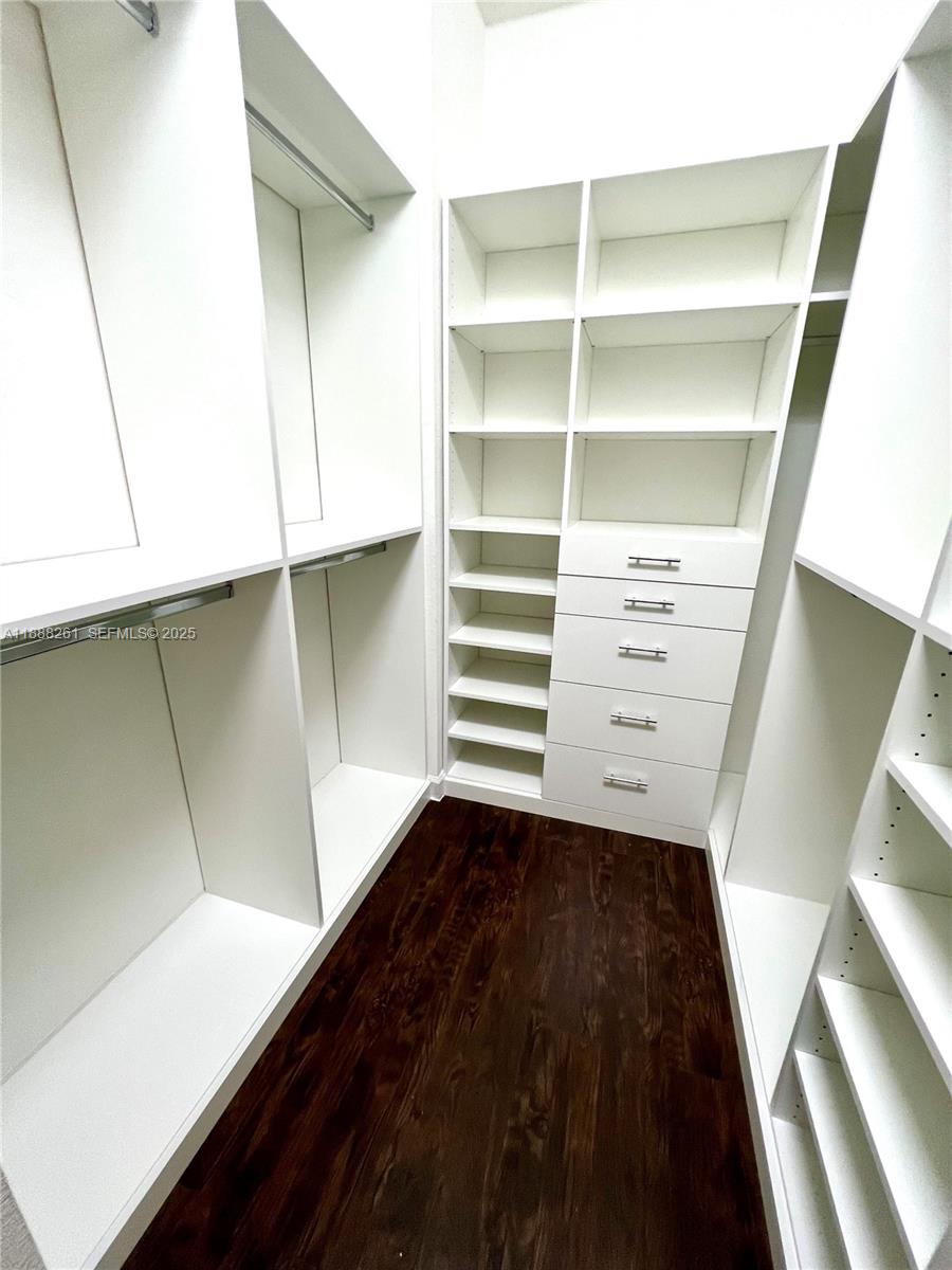 400 Northeast 208th Terrace, Unit 400 Miami, FL 33179 - Photo 28 of 53 a view of walk in closet with empty racks