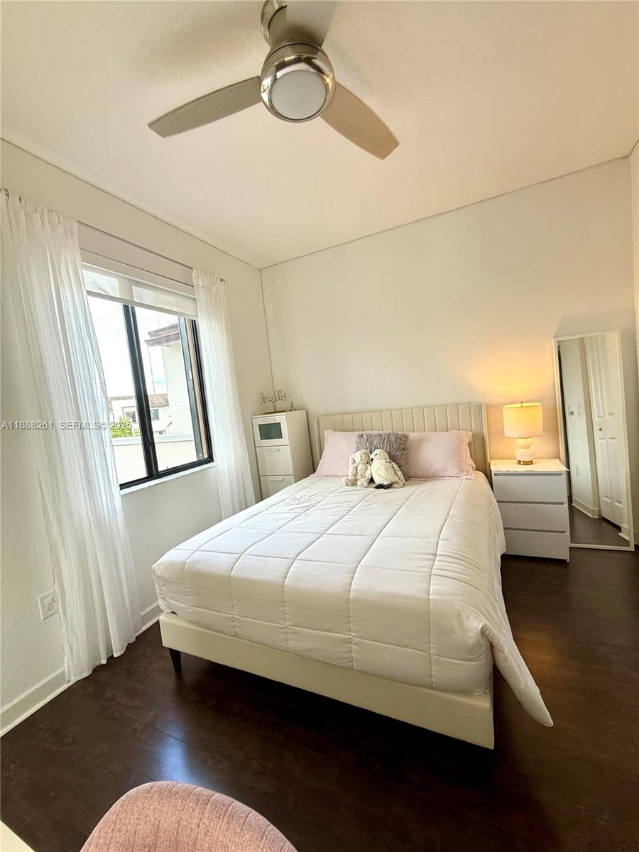 400 Northeast 208th Terrace, Unit 400 Miami, FL 33179 - Photo 30 of 53 a bedroom with a bed window and a table